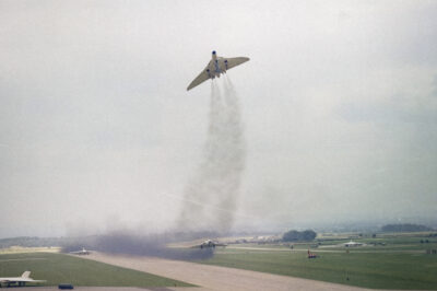 Three Avro Vulcan B2s of No. 617 Squadron, carrying Blue Steel training rounds, take off in quick succession, demonstrating a dispersal scramble at RAF Scampton, August 9, 1963.