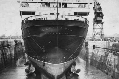 RMS Aquitania was docked in the King George V Drydock in 1937, where newly installed propellers were visible following water drainage. The propellers, scaled-down versions of those on the Queen Mary, featured four blades per screw with increased surface area. Despite this enhancement, the desired speed boost was not attained. Consequently, extensive condenser work was undertaken during the 1937 refit to enhance the ship’s 62,000 horsepower engines. This upgrade proved effective, enabling Aquitania to surpass 24.50 knots on transatlantic crossings beginning in spring 1938.