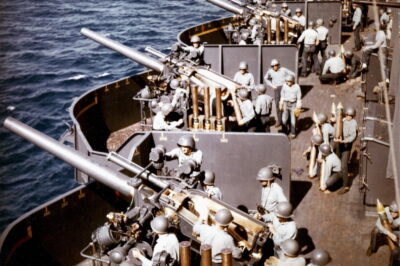 The 5″/25 (127 mm) battery aboard the U.S. Navy battleship USS New Mexico (BB-40) prepares to fire during the bombardment of Saipan, 15 June 1944.