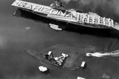 USS Bennington sailing by the wreck of USS Arizona, Honolulu, US Territory of Hawaii, 30 May 1958.