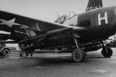 An experimental XAAM-N-2 Sparrow missile is mounted on a Grumman F6F-5 Hellcat in January 1950. The underwing pod housed radar instrumentation for guidance tests. This marked the early stages of U.S. air-to-air missile development.