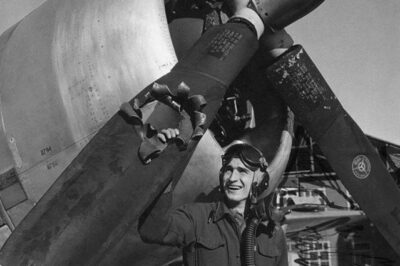 19-year-old Lieutenant Edwin Wright looks upon his airplane after being hit by an 88 mm shell, over the city of Munster, Germany