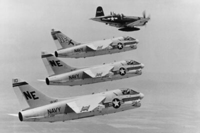 Lynn Garrison pilots a French-built F4U-7 Corsair in formation with three A-7A Corsair II jets, July 7, 1967. The image highlighted the transition from piston to jet power in carrier aviation. The A-7 was nicknamed the “SLUF” — Short Little Ugly Fella — but it became one of the Navy’s most reliable strike aircraft.