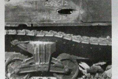 Long 8.8 cm gun penetration through the side of a Sherman near the rear. Even after hitting at quite an extreme angle, the round passed through the fuel tank, hit the engine and then stopped at the rear armour.